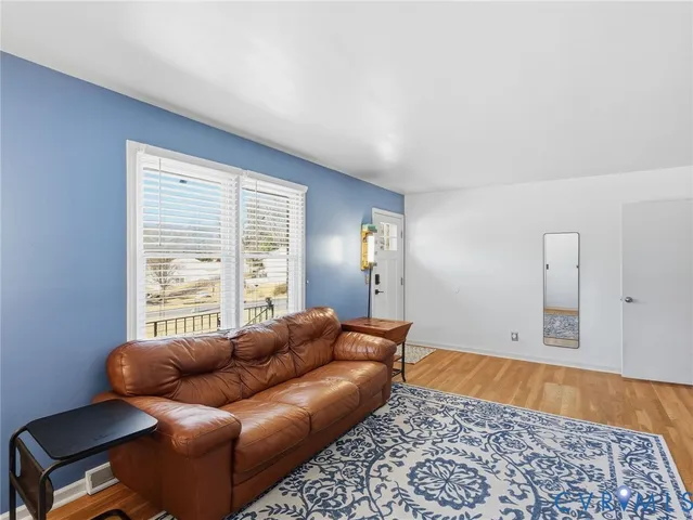 a living room with furniture and a rug