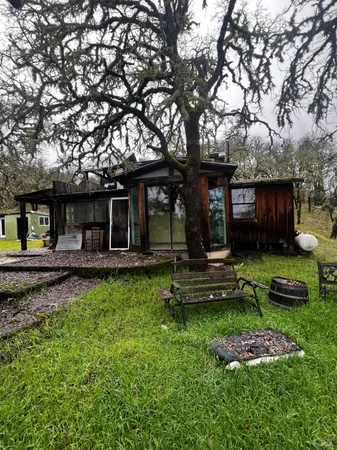 a view of a house with backyard and sitting area