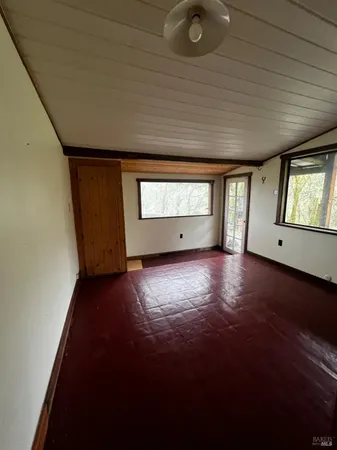 a gym with lots of water heater and view of living room