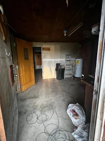 a view of a backyard with plants and a patio