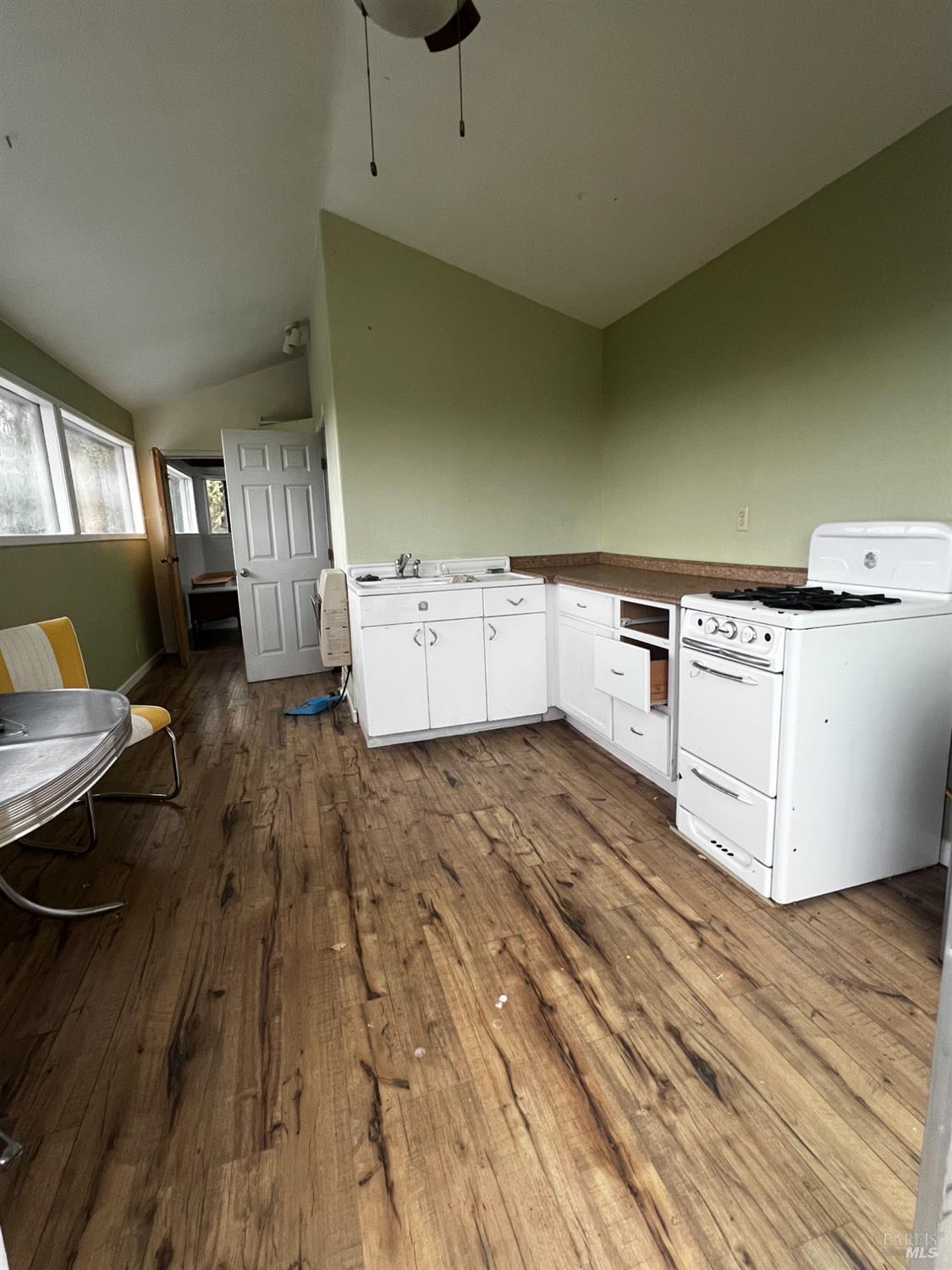 23040 Poonkinney Road Covelo, CA 95428 - Photo 50 of 77 a kitchen with a wooden floor and white stainless steel appliances