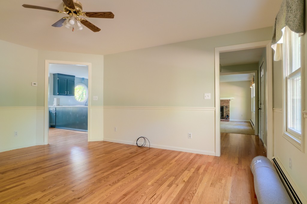 140 Bullard Road Oakham, MA 01068 - Photo 12 of 29 a view of a livingroom with wooden floor and a ceiling fan