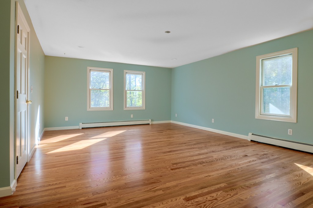 140 Bullard Road Oakham, MA 01068 - Photo 17 of 29 a view of an empty room with window and wooden floor