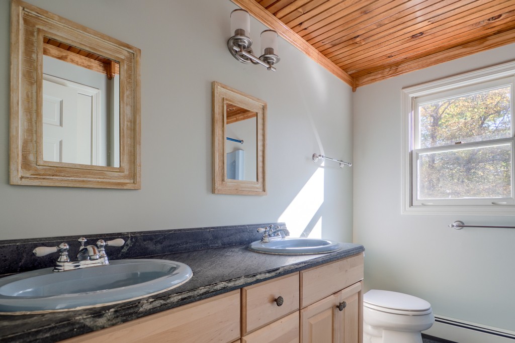 140 Bullard Road Oakham, MA 01068 - Photo 21 of 29 a bathroom with a granite countertop sink and a toilet