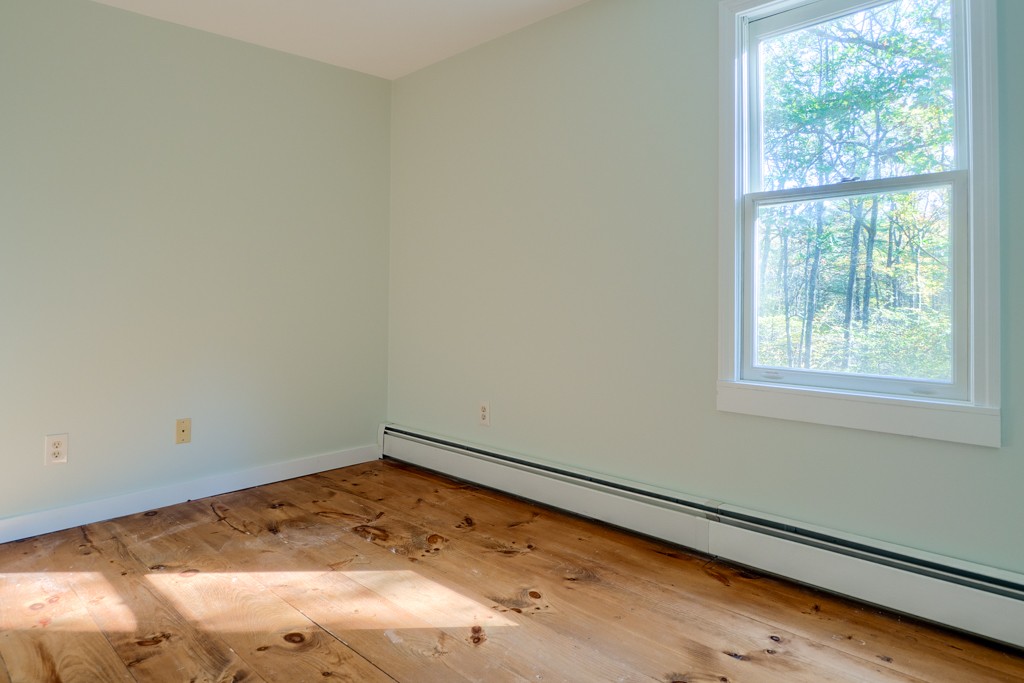 140 Bullard Road Oakham, MA 01068 - Photo 25 of 29 an empty room with a window