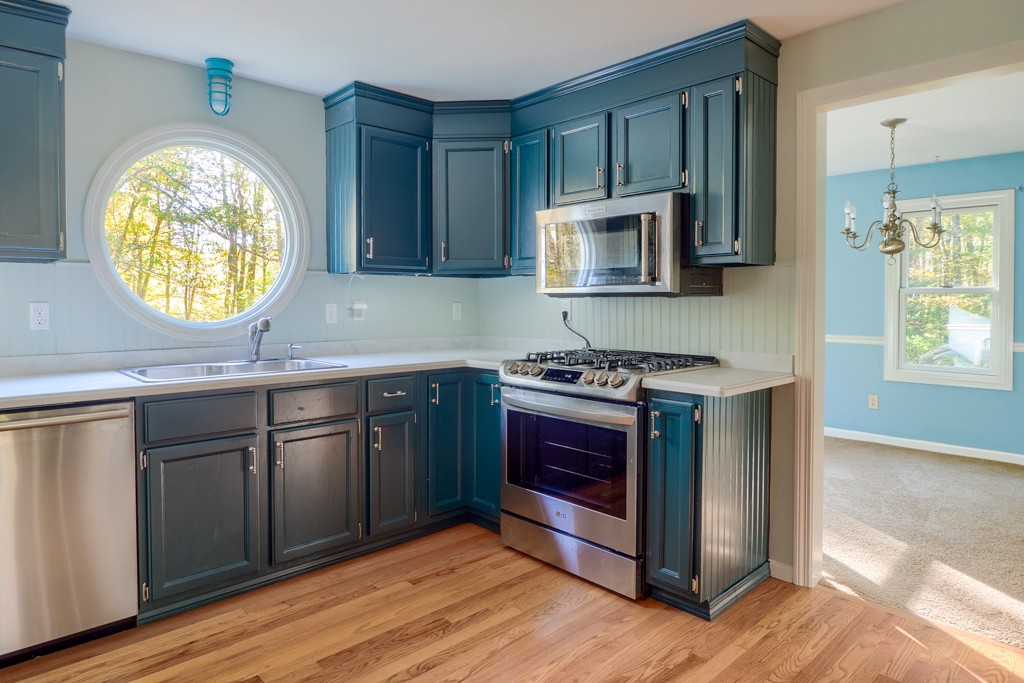 140 Bullard Road Oakham, MA 01068 - Photo 5 of 29 a kitchen with stainless steel appliances granite countertop a stove a sink and a microwave