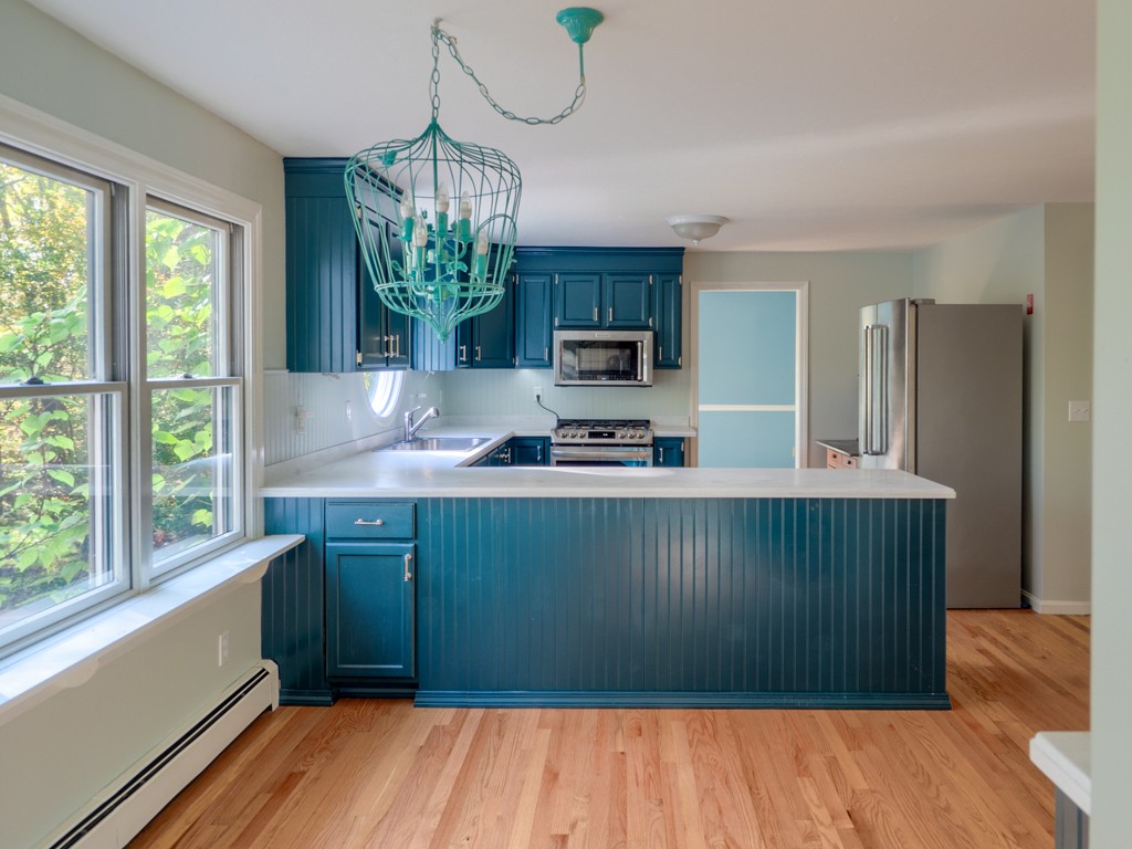 140 Bullard Road Oakham, MA 01068 - Photo 9 of 29 a kitchen with stainless steel appliances granite countertop a refrigerator a stove a sink and a wooden floors