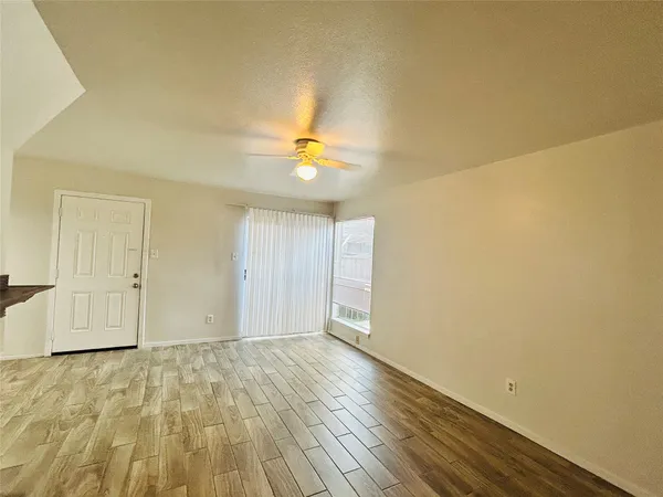 a view of an empty room and wooden floor