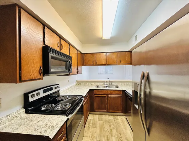 a kitchen with a stove a sink and a microwave