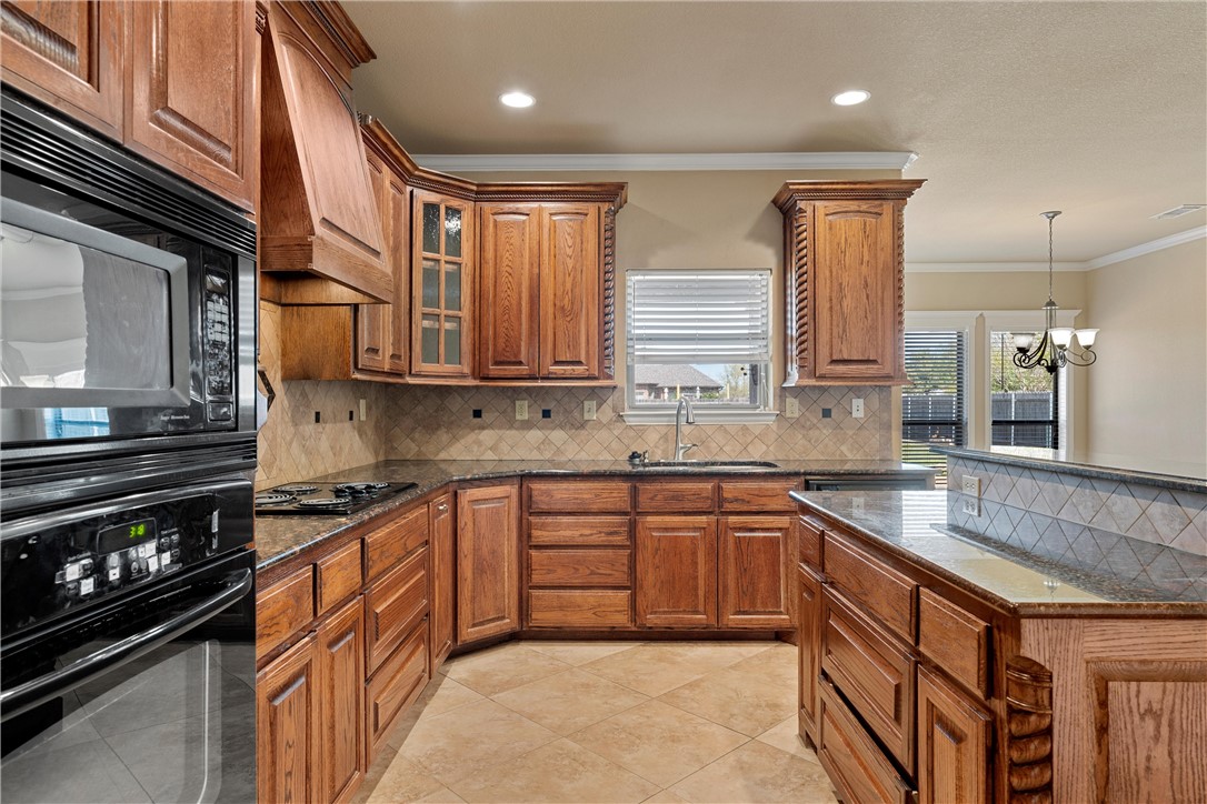 403 South Cedar Ridge Circle Robinson, TX 76706 - Photo 18 of 46 a kitchen with stainless steel appliances granite countertop a stove a sink and a microwave