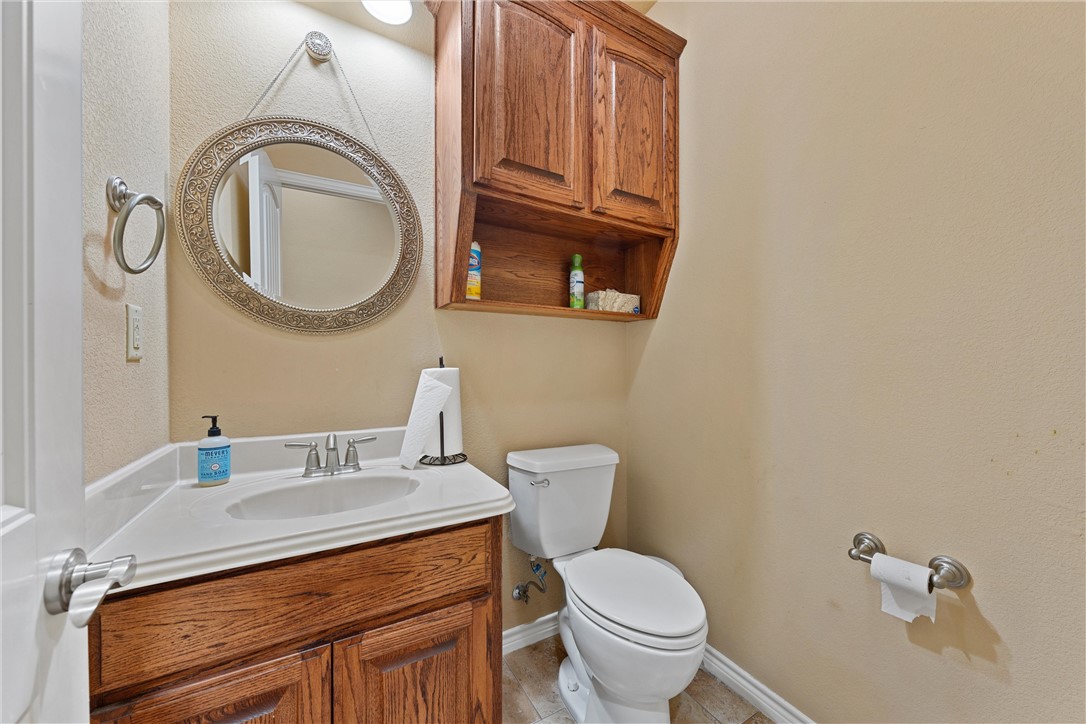 403 South Cedar Ridge Circle Robinson, TX 76706 - Photo 28 of 46 a bathroom with a granite countertop toilet sink and mirror