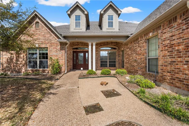 a front view of a house with garden