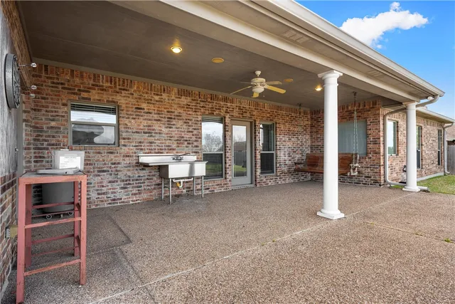a view of a hall with dining table and chairs