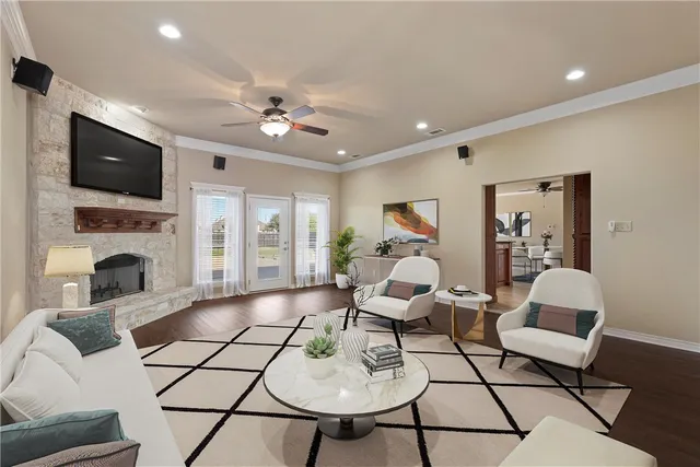 a living room with furniture a fireplace and a flat screen tv