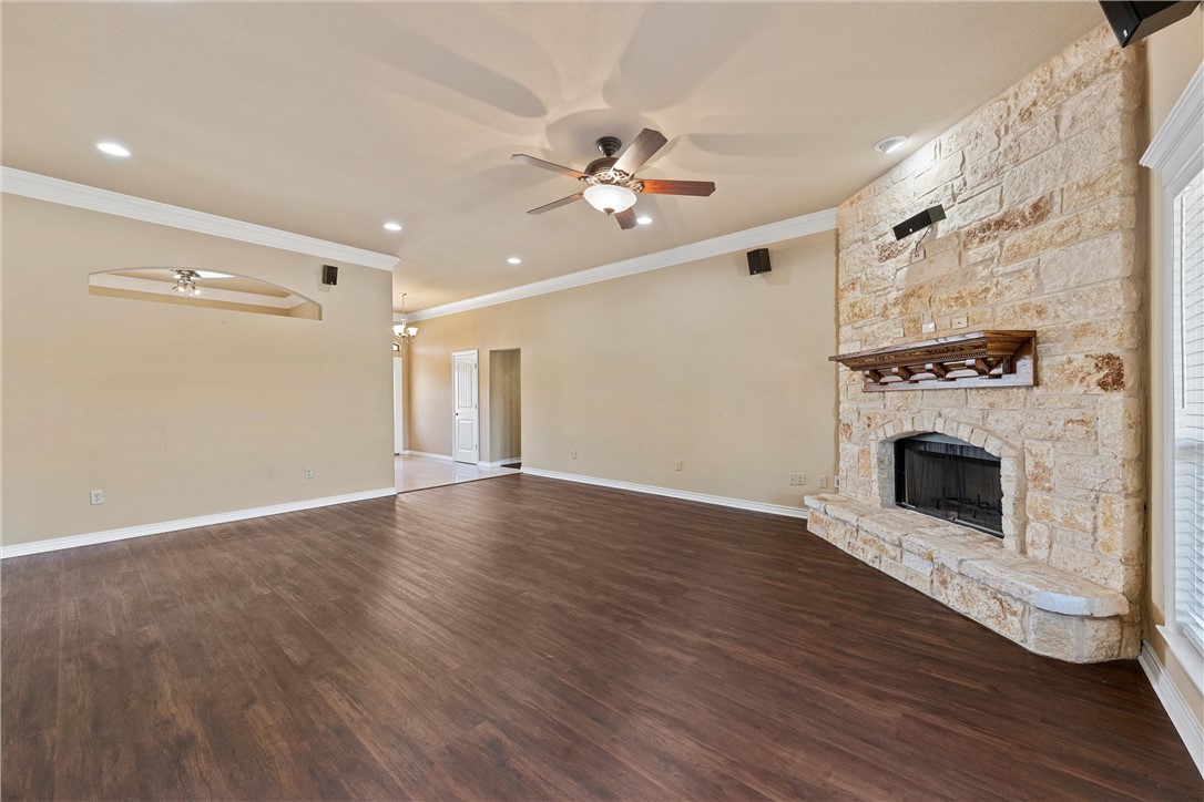 403 South Cedar Ridge Circle Robinson, TX 76706 - Photo 9 of 46 a view of a livingroom with wooden floor a ceiling fan a fireplace and windows