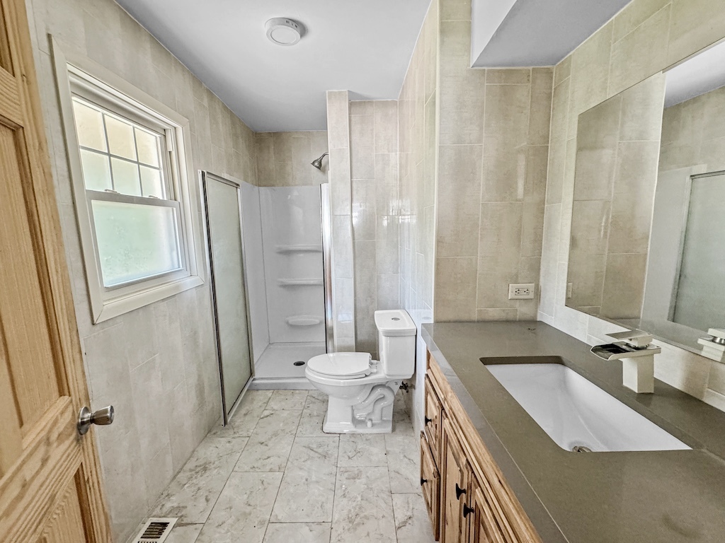 15831 Trumbull Avenue Markham, IL 60428 - Photo 11 of 25 a bathroom with a sink a toilet and shower