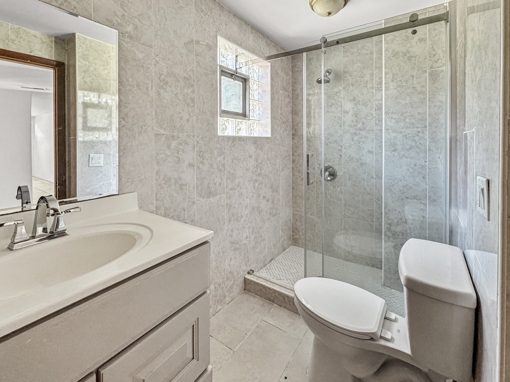15831 Trumbull Avenue Markham, IL 60428 - Photo 15 of 25 a bathroom with a sink toilet and shower