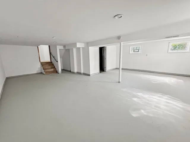 a view of a house with a big yard and large trees