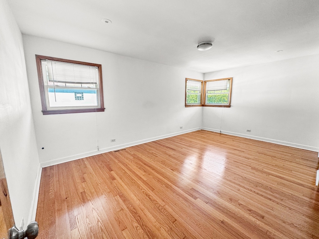 15831 Trumbull Avenue Markham, IL 60428 - Photo 10 of 25 an empty room with wooden floor and windows