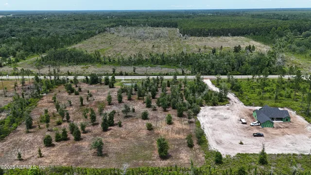 an aerial view of a house with a yard