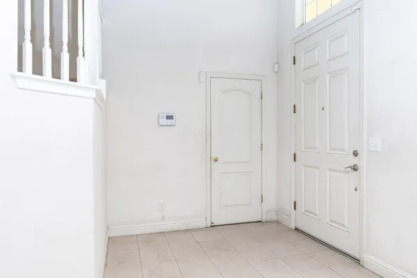 a view of an empty room with fireplace and stairs