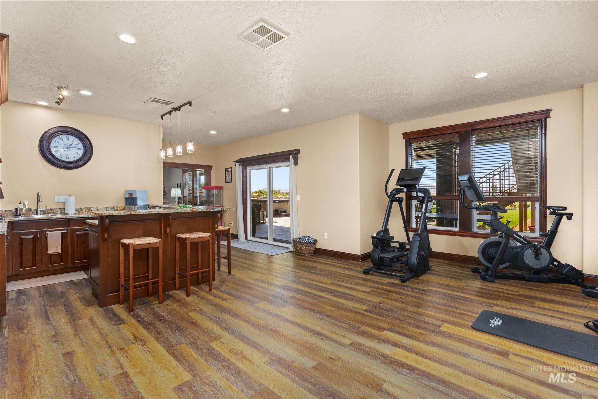 13683 Hockberger Ranch Road Caldwell, ID 83607 - Photo 27 of 50 Wood-finish flooring, recessed lighting, and a built-in wet bar with pendant lighting