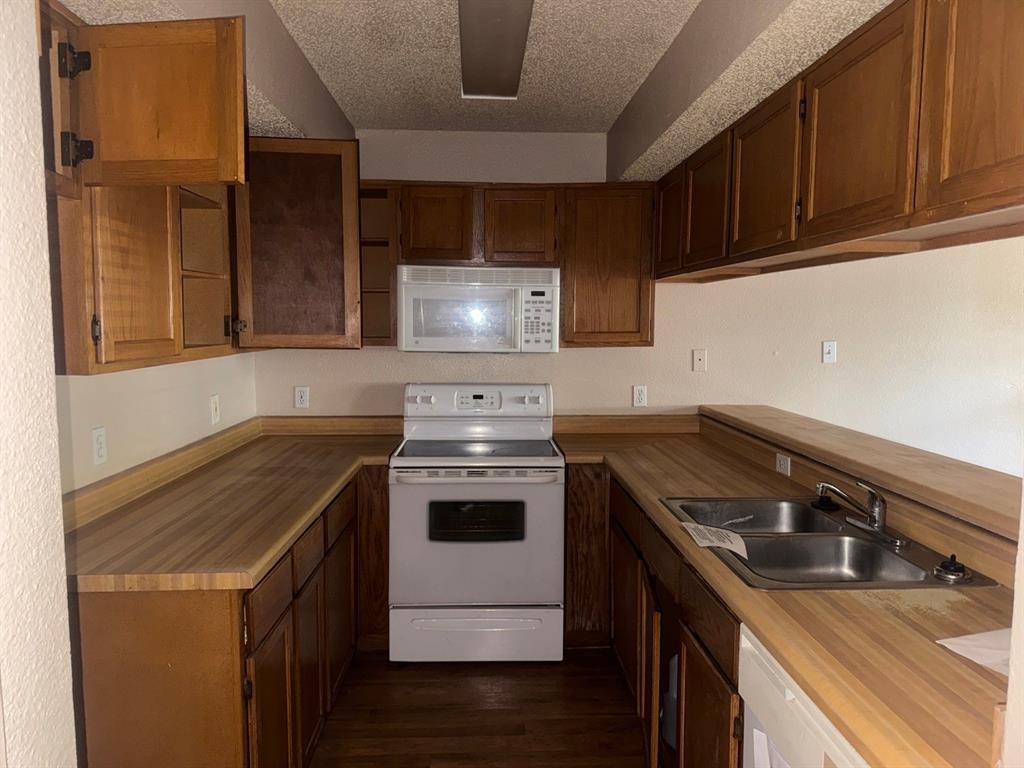 6108 Abrams Road, Unit 103 Dallas, TX 75231 - Photo 12 of 17 a kitchen with a stove and a sink