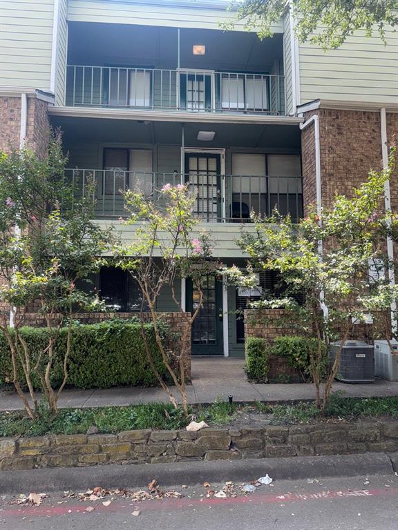 6108 Abrams Road, Unit 103 Dallas, TX 75231 - Photo 14 of 17 a front view of a house with garden