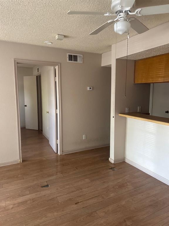 6108 Abrams Road, Unit 103 Dallas, TX 75231 - Photo 3 of 17 a view of a room with a ceiling fan and hardwood floor