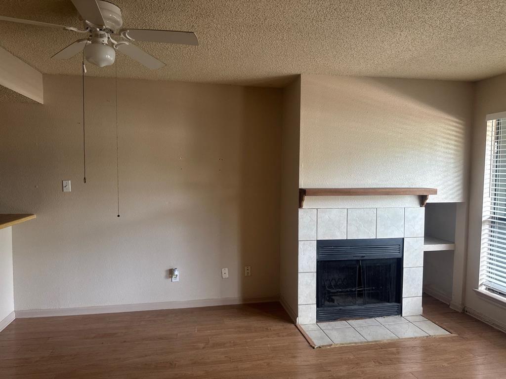 6108 Abrams Road, Unit 103 Dallas, TX 75231 - Photo 6 of 17 an empty room with fireplace