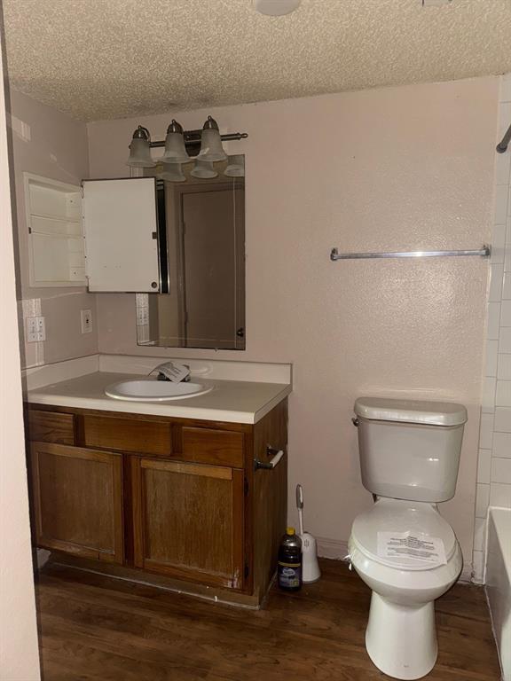 6108 Abrams Road, Unit 103 Dallas, TX 75231 - Photo 10 of 17 a bathroom with a toilet sink and mirror