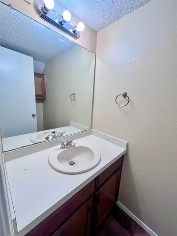 a bathroom with a sink a mirror and vanity