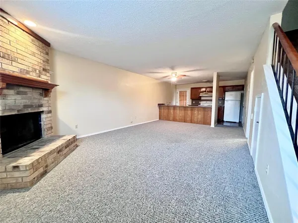 an empty room with furniture and a fireplace