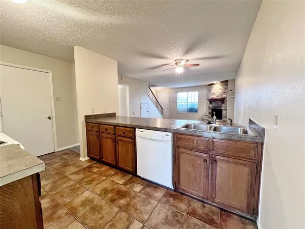 a kitchen with a sink cabinets and appliances