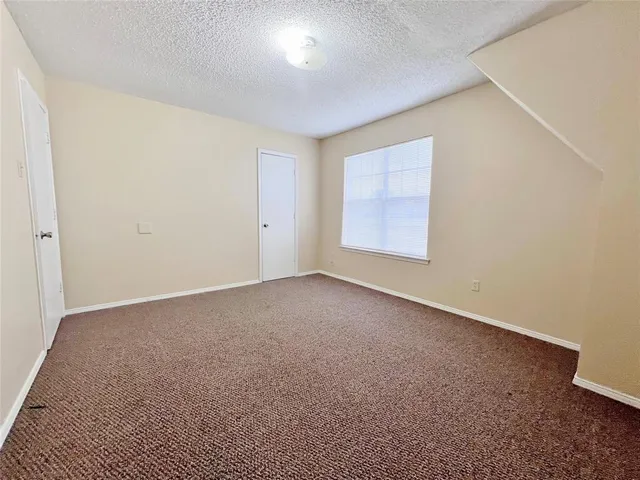 an empty room with a empty space and windows