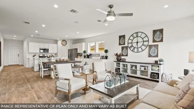a living room with furniture kitchen view and a chandelier
