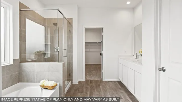 a bathroom with a tub shower and a sink