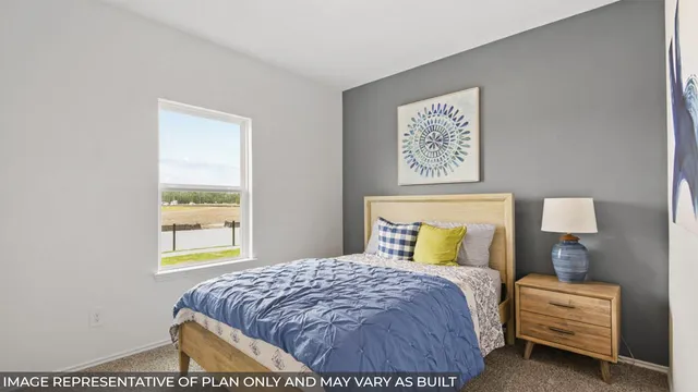 a bedroom with a bed and a wooden floor