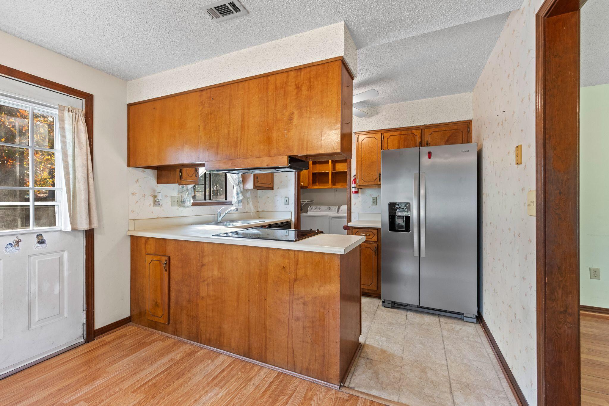 144 Oak Terrace Drive Crestview, FL 32539 - Photo 15 of 61 a kitchen with stainless steel appliances a sink and a refrigerator