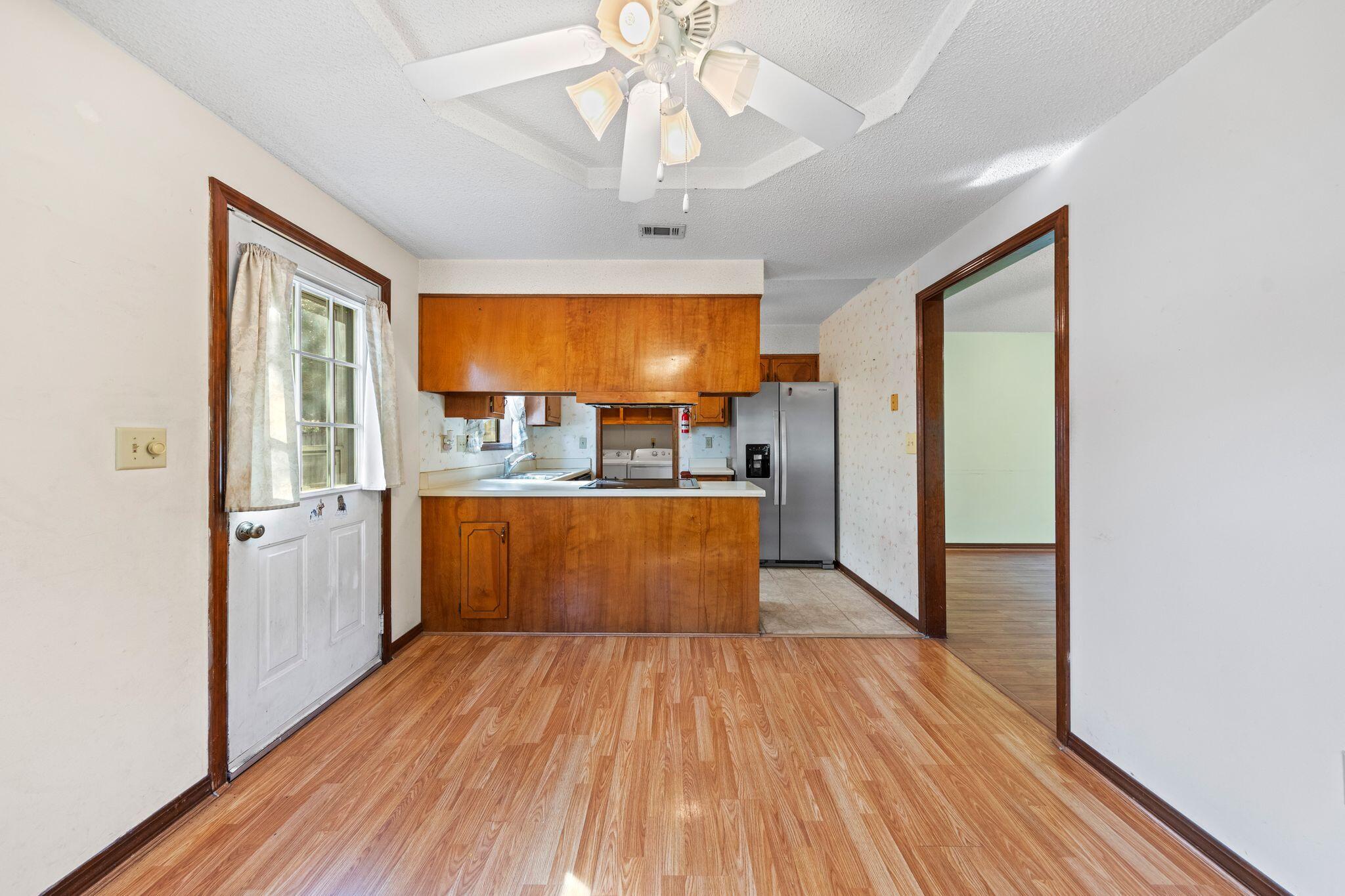 144 Oak Terrace Drive Crestview, FL 32539 - Photo 16 of 61 a view of kitchen with stainless steel appliances granite countertop a stove and a wooden floors