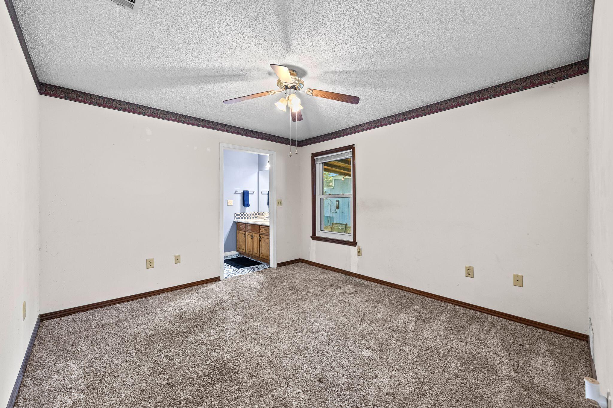 144 Oak Terrace Drive Crestview, FL 32539 - Photo 22 of 61 an empty room with chandelier fan and windows