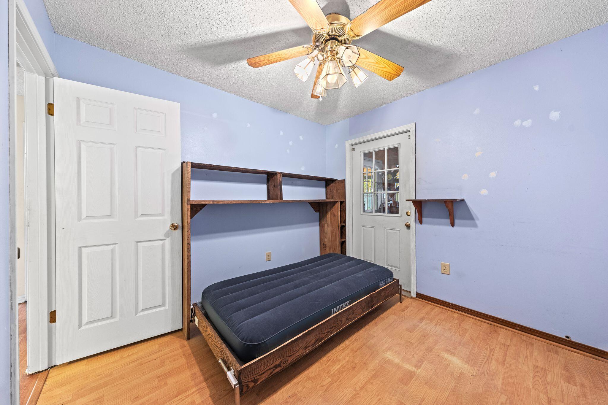 144 Oak Terrace Drive Crestview, FL 32539 - Photo 28 of 61 a bedroom with a bed and a chandelier