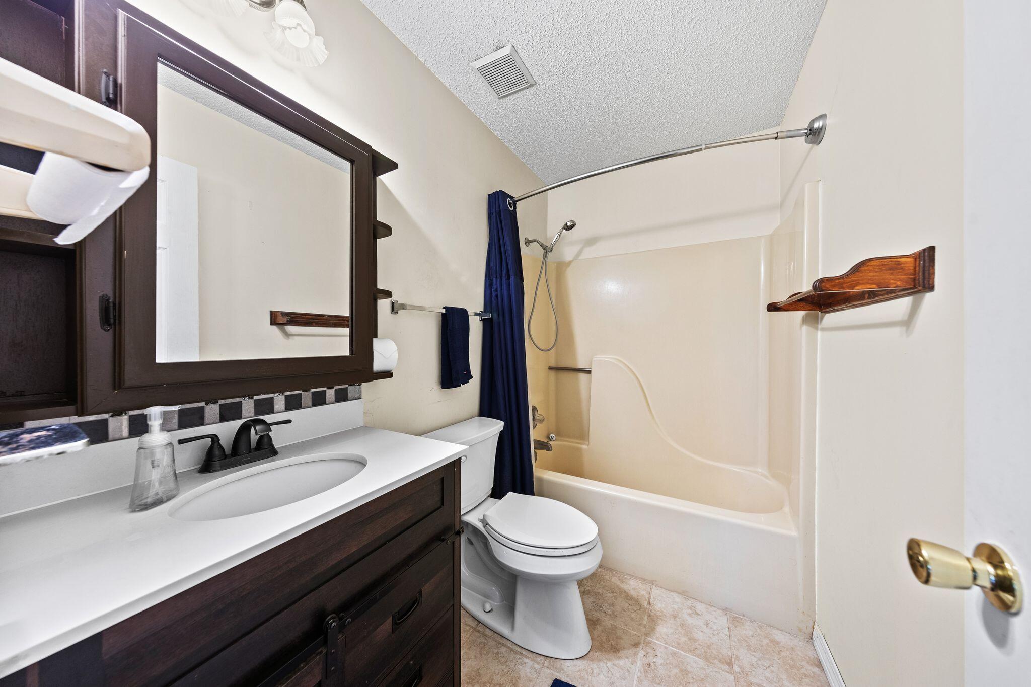144 Oak Terrace Drive Crestview, FL 32539 - Photo 34 of 61 a bathroom with a double vanity sink toilet mirror and shower