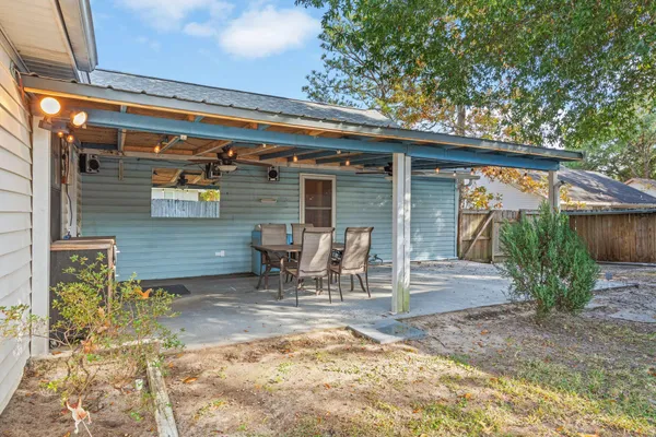 a view of a house with a small yard and wooden fence