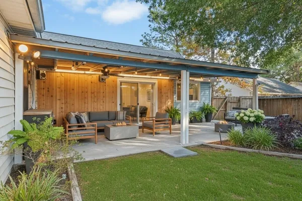 a backyard of a house with table and chairs