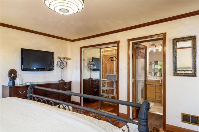 a bathroom with a granite countertop toilet sink and mirror