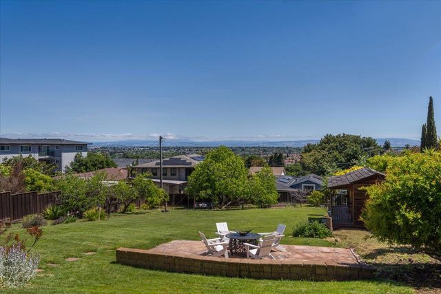 a view of a chairs and table in the patio