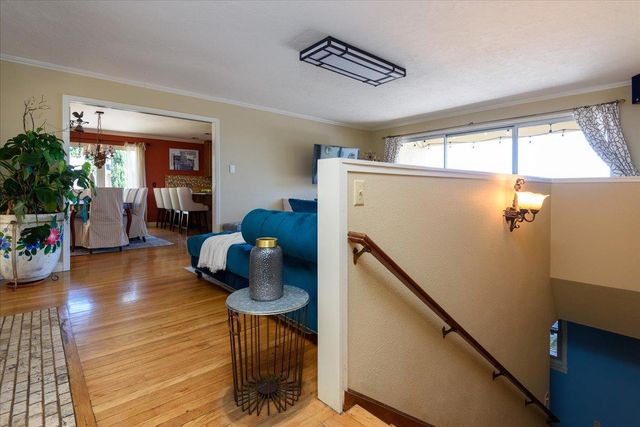 a living room with pool table chairs and a fireplace