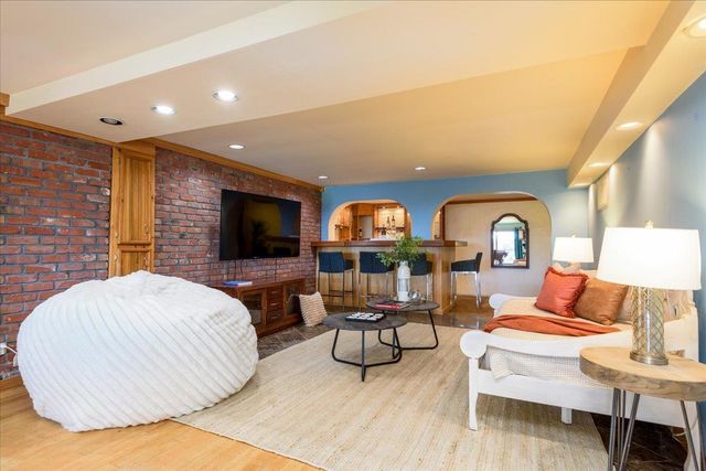 a living room with furniture a dining table and a fireplace