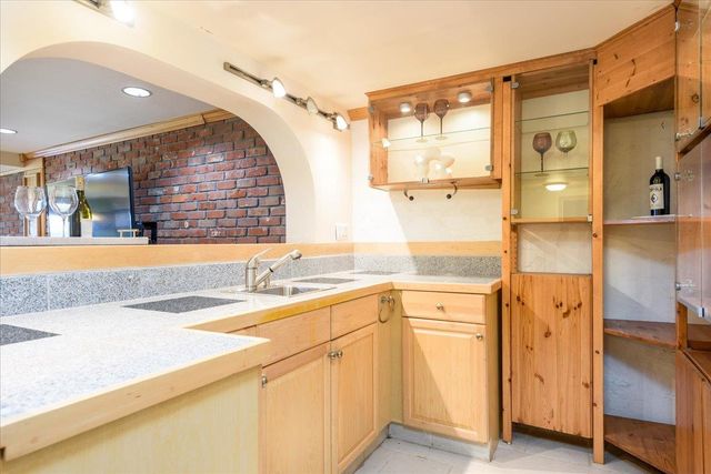 a hallway with furniture and a potted plant